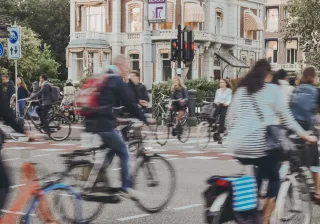 Cyclists in traffic at a busy intersection