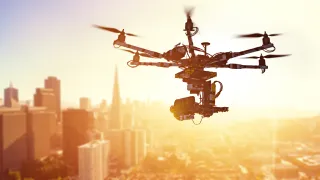 Photo of a drone flying over a city