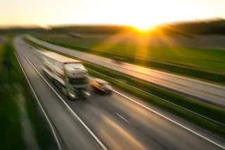 Photo of a truck driving down the motorway in the sunset