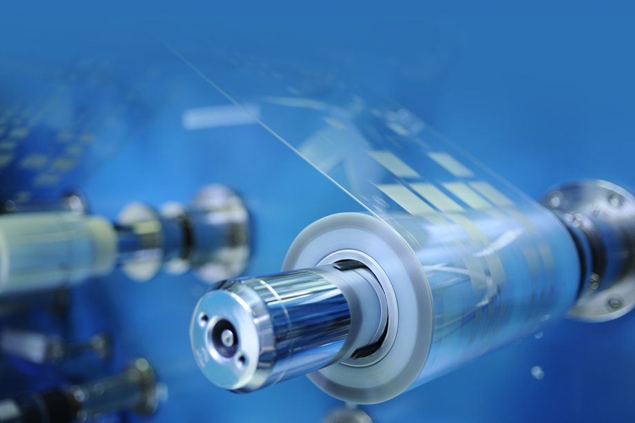 The image shows a roll of translucent material with electronics printed on it.