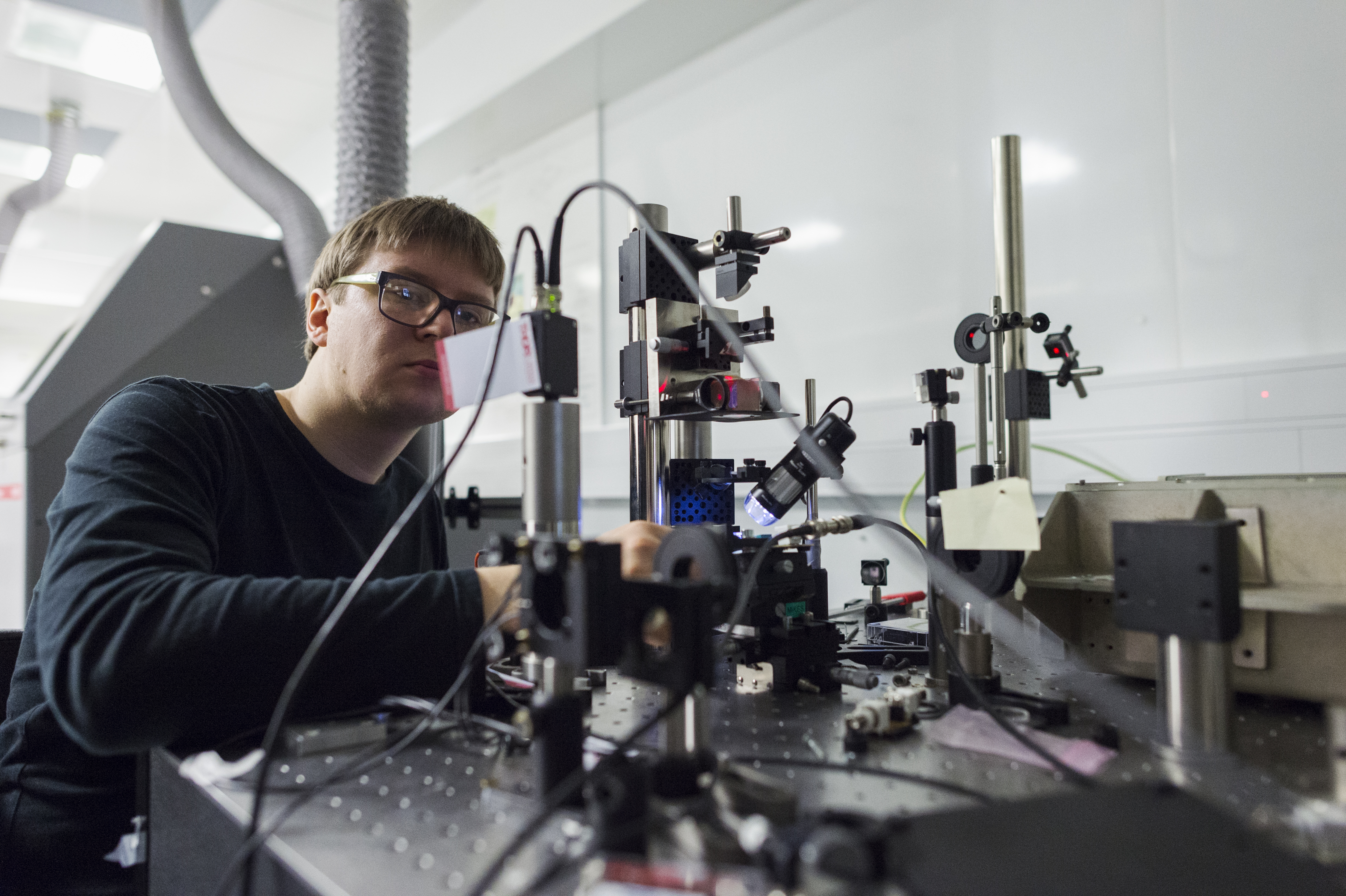 Photo of VTT MIKES researcher using measurement equipment
