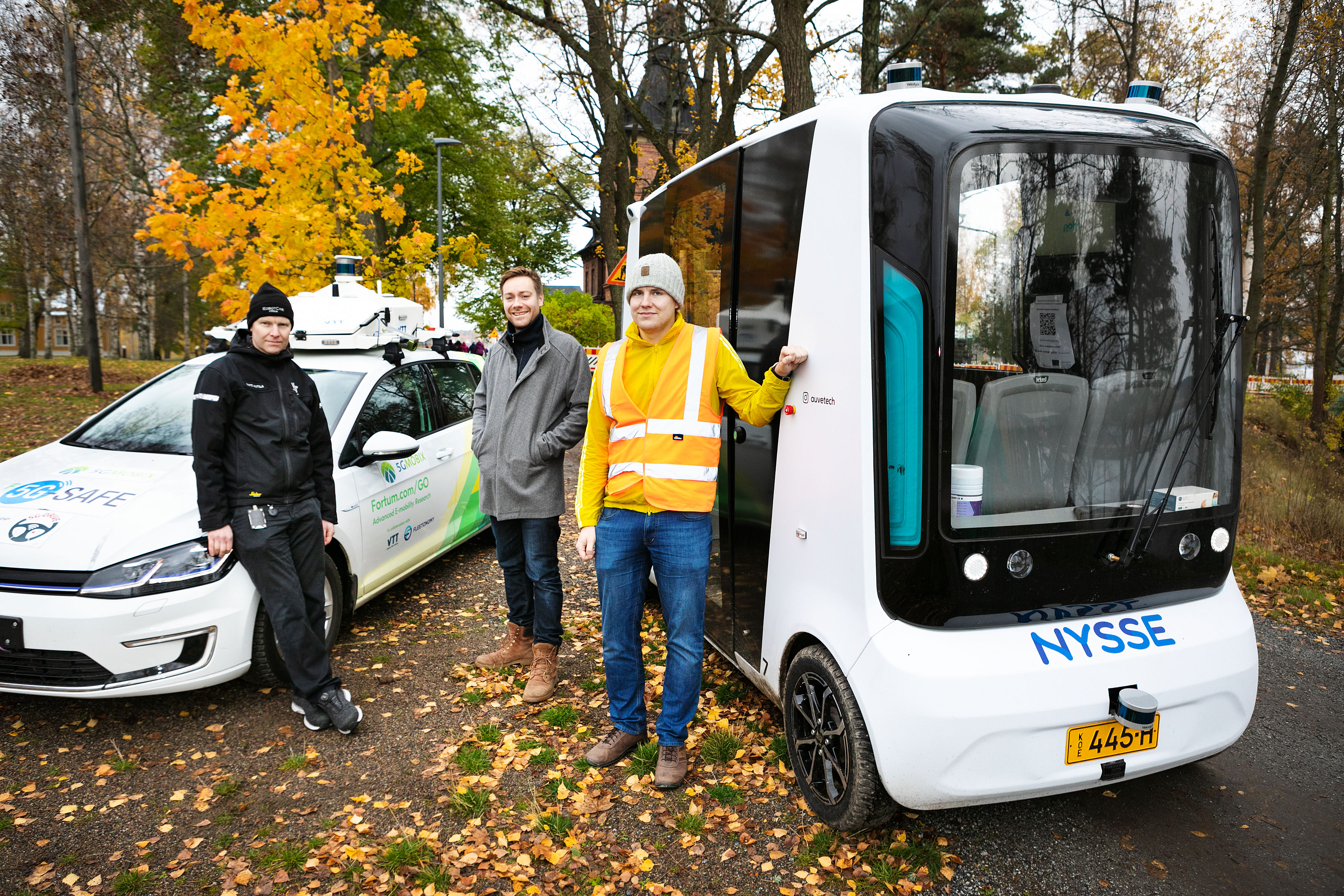 Photo of the Roboride vehicle and Matti Kutila, Tatu Nieminen and Ville Lepola