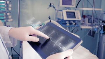 Close up of hands using a heart monitor screen