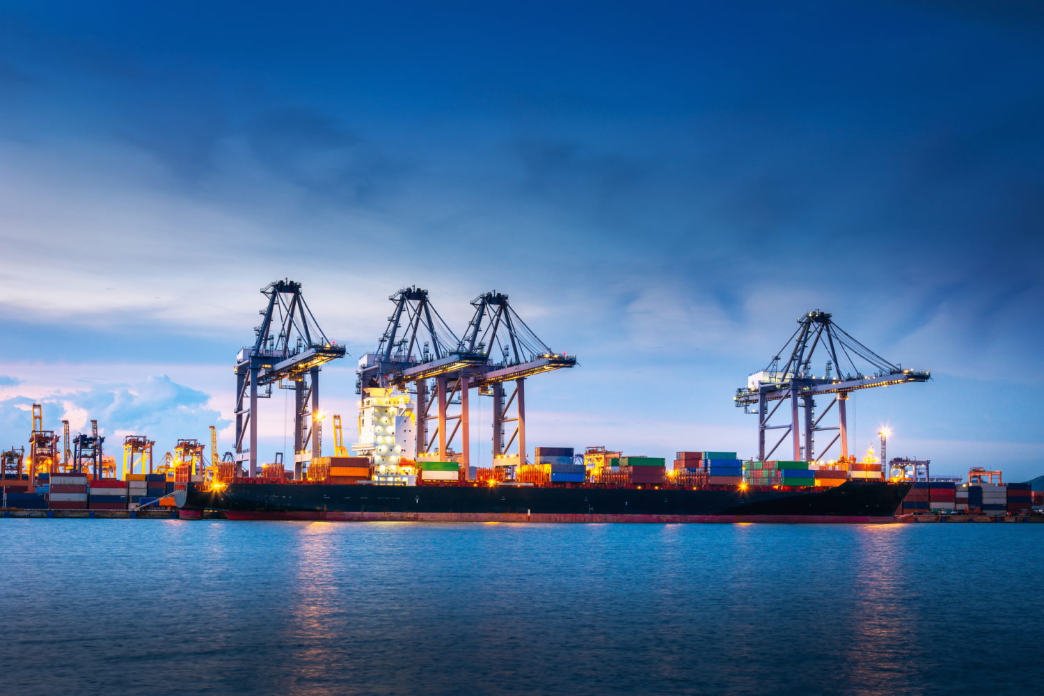 Maritime port landscape with cranes, ship and cargo