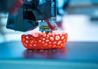 A 3D printing machine is printing a round shape