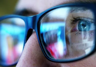 A closeup photo of a person&#039;s eyes, who is wearing glasses.