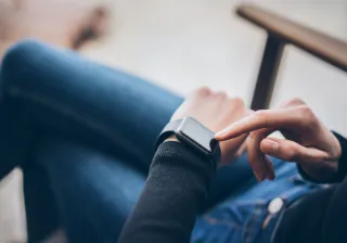 A photo of a person using a smartwatch.