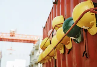 Photo shows a row of construction workers&#039; hard hats