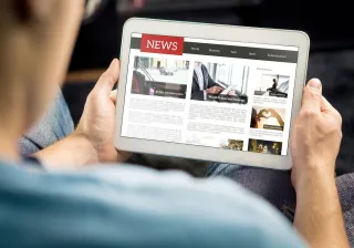Man reading news site on tablet