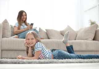A woman and a child are resting in a living room