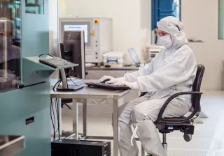 researcher sitting at a table in micronova cleanroom