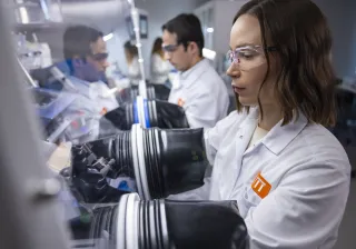 Researchers working with gloves on