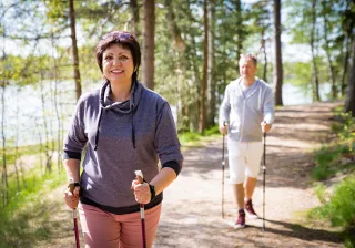 illustrativeimagepersonsnordicwalkinginforest