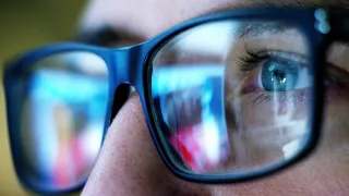 A closeup photo of a person&#039;s eyes, who is wearing glasses.