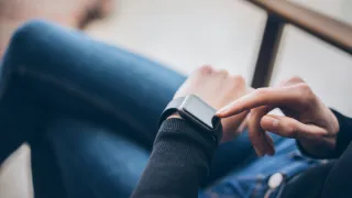 A photo of a person using a smartwatch.