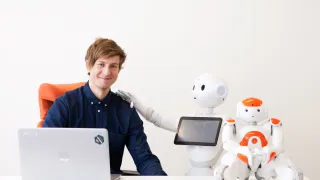 A photo of VTT&#039;s research scientist Petri Tikka and the Pepper robot.