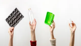 käden pitelevät muovituotteita