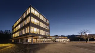 Wooden office building in the evening lights