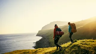 people hiking near water