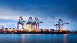 Maritime port landscape with cranes, ship and cargo