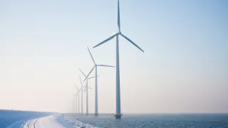 Snowywindmillsonseawintertime