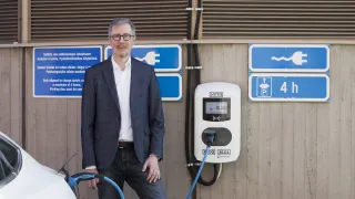 Marko Paakkinen standing at a electric car charging station
