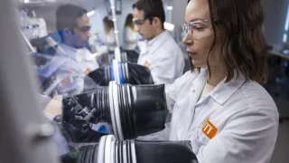 Researchers working with gloves on