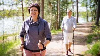 illustrativeimagepersonsnordicwalkinginforest