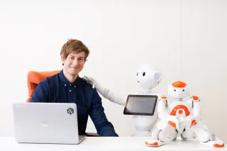 A photo of VTT&#039;s research scientist Petri Tikka and the Pepper robot.