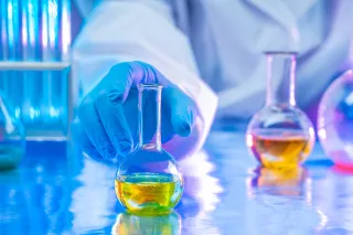Photo of hand handling chemistry samples in a laboratory