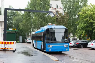 Electric bus at a stop is charged by wireless induction charging