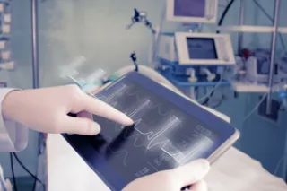 Close up of hands using a heart monitor screen