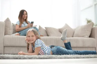 A woman and a child are resting in a living room