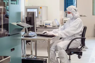 researcher sitting at a table in micronova cleanroom