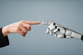 robot and human hands touching