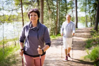 illustrativeimagepersonsnordicwalkinginforest