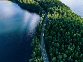 cars on a road between two lakes