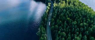 cars on a road between two lakes