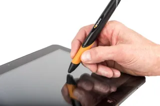 Photo of a hand holding a pen against a tablet screen.