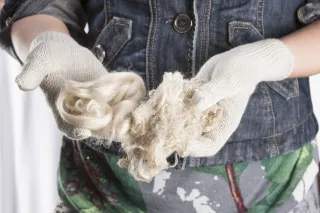 person holding textile yarn