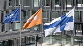 the flags of NATO, VTT and Finland side by side