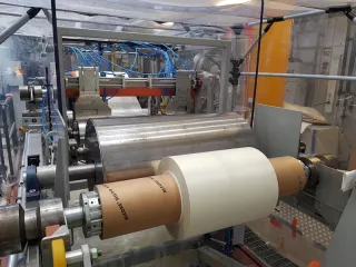 Production of woodbased barrier film on a roll
