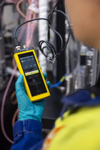 A scientist operating the HTE Highthroughput hydrotreatment reactor